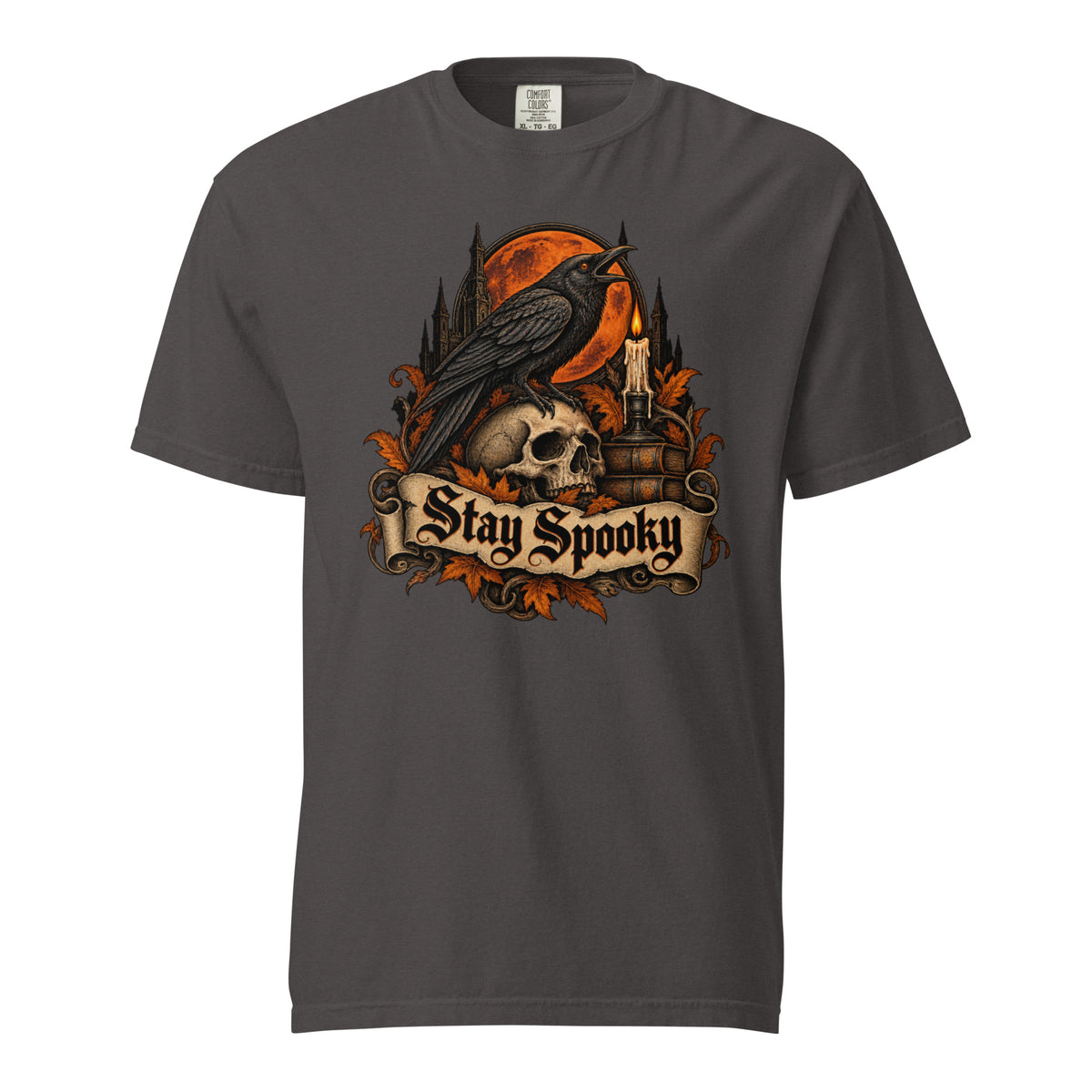Front view of a graphite T-shirt with a raven perched on a skull before an orange full moon and ornate “Stay Spooky” lettering.