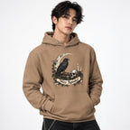 Front view of a Latte hoodie modeled by a person, featuring a raven, skull, crescent moon, candle, ivy and “Stay Spooky” artwork.