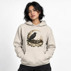 Front view of an Oatmeal Heather hoodie featuring a raven, skull, crescent moon, candle and “Stay Spooky” scroll artwork.