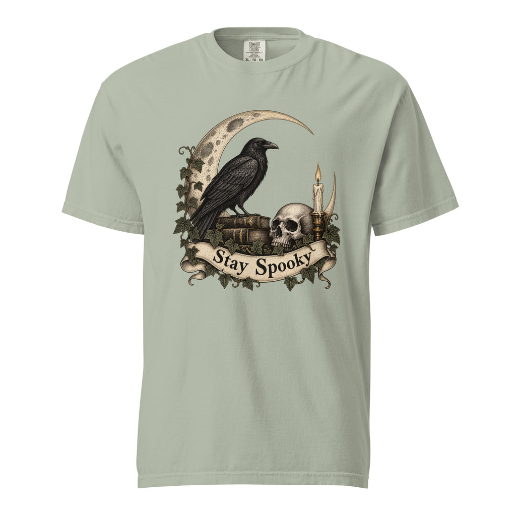 Front view of a Bay T-shirt featuring a black raven, skull, crescent moon, candle and ivy beneath a “Stay Spooky” scroll.
