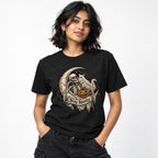 Model wearing a black T-shirt with a gothic skeleton, ghost and carved pumpkin beneath a crescent moon and Stay Spooky banner