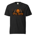 Front view of a black T-shirt with a glowing jack-o'-lantern held by skeletal hands and ornate orange “Stay Spooky” lettering.