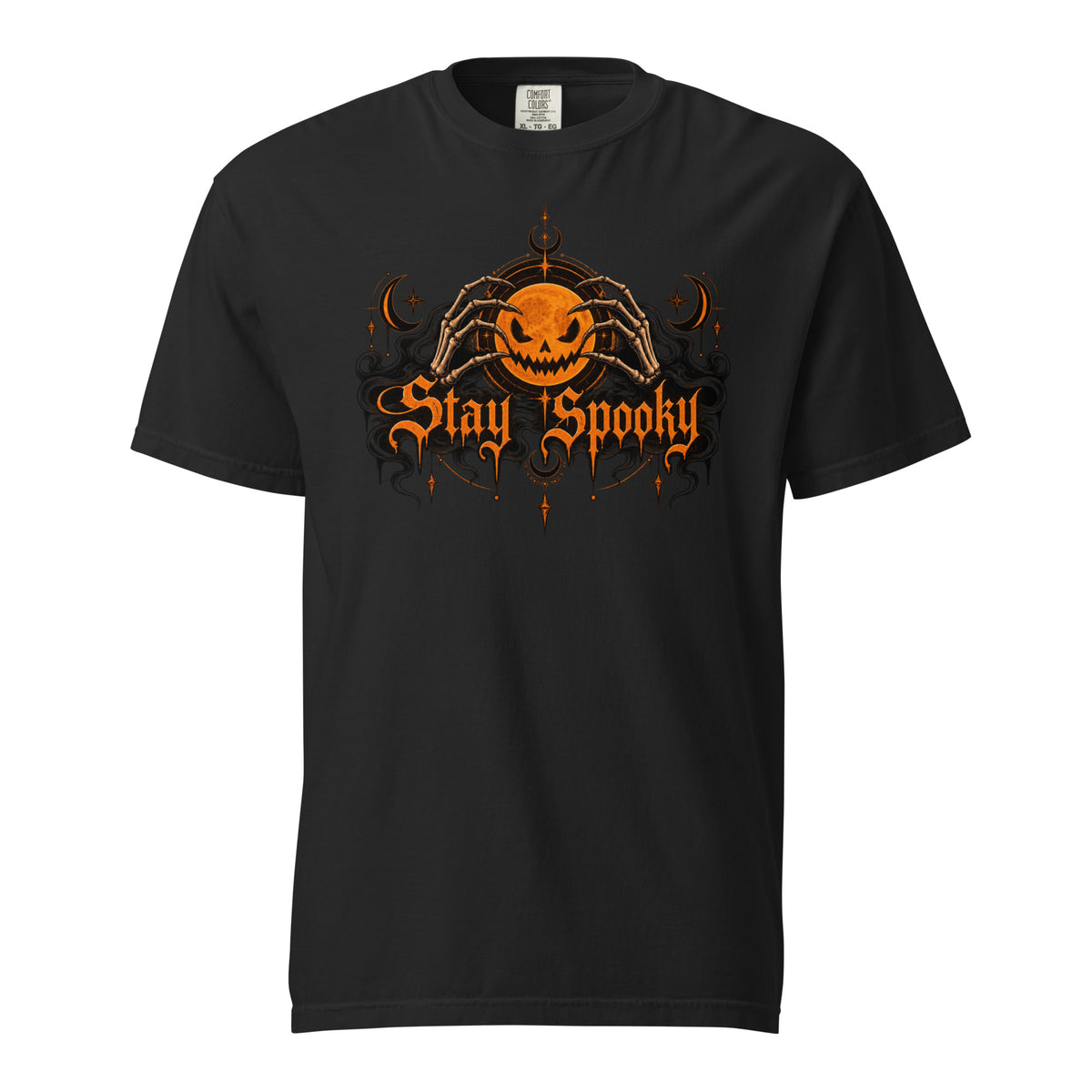 Front view of a black T-shirt with a glowing jack-o'-lantern held by skeletal hands and ornate orange “Stay Spooky” lettering.