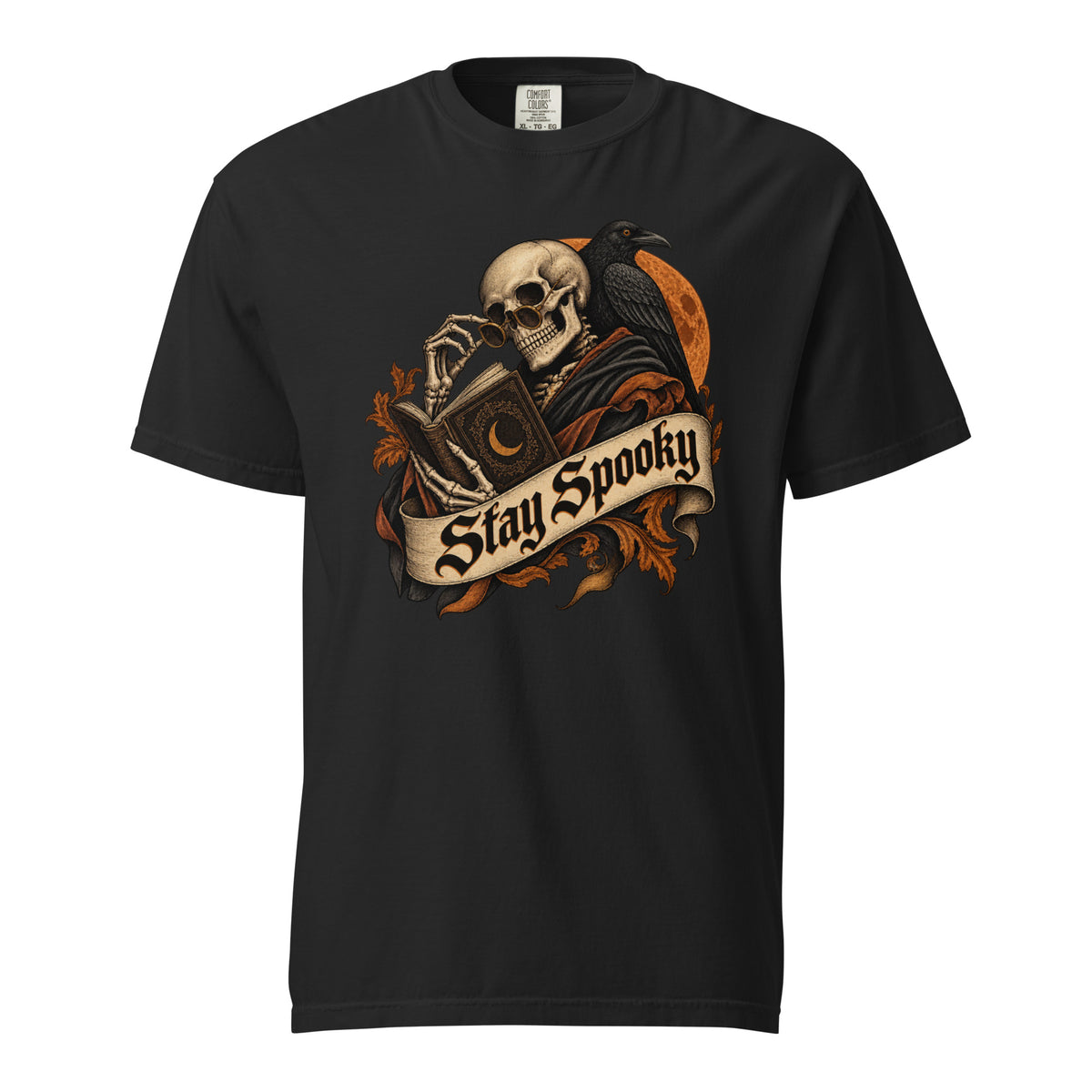 Front view of a black T-shirt featuring a skull reading an ornate book beside a raven and orange moon, with a Stay Spooky banner.
