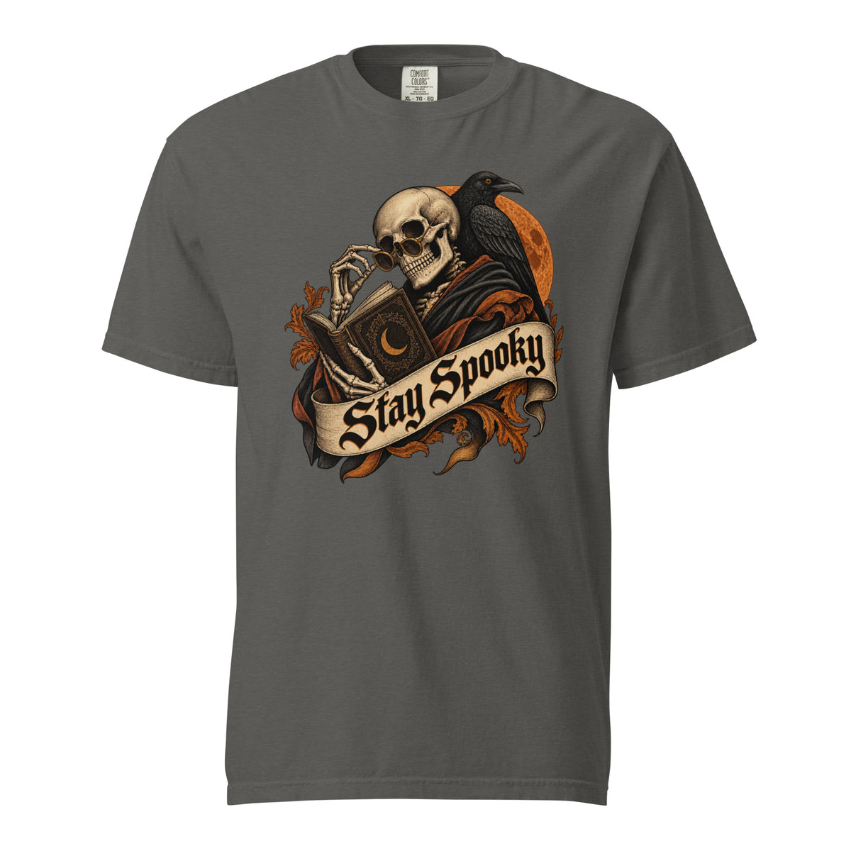 Front view of a Pepper T-shirt featuring a gothic Skull reading an ornate book beside a Raven and orange Moon under a Stay Spooky banner.
