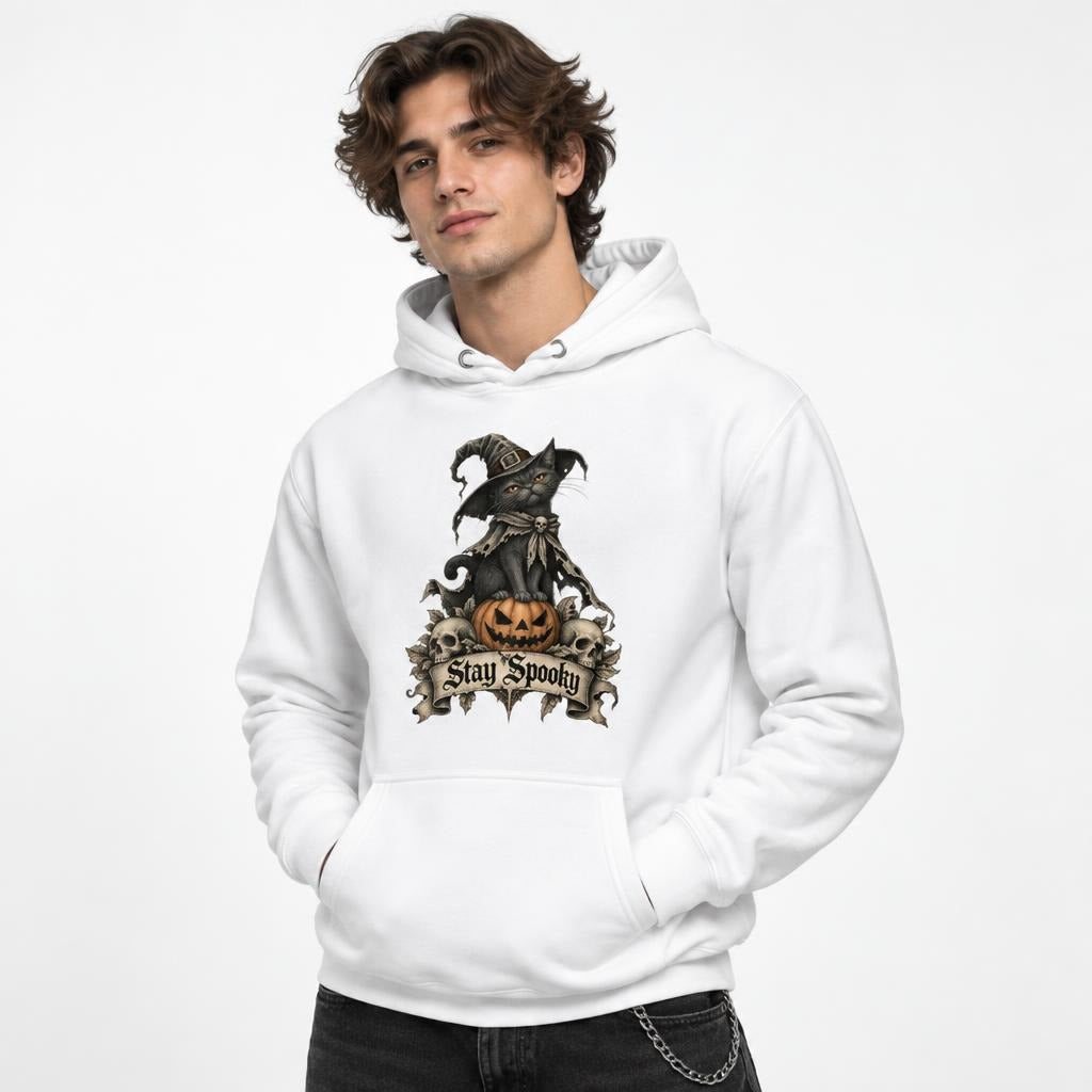 Front view of a model wearing a white hoodie with a black cat in a witch hat on an orange pumpkin and “Stay Spooky” text.