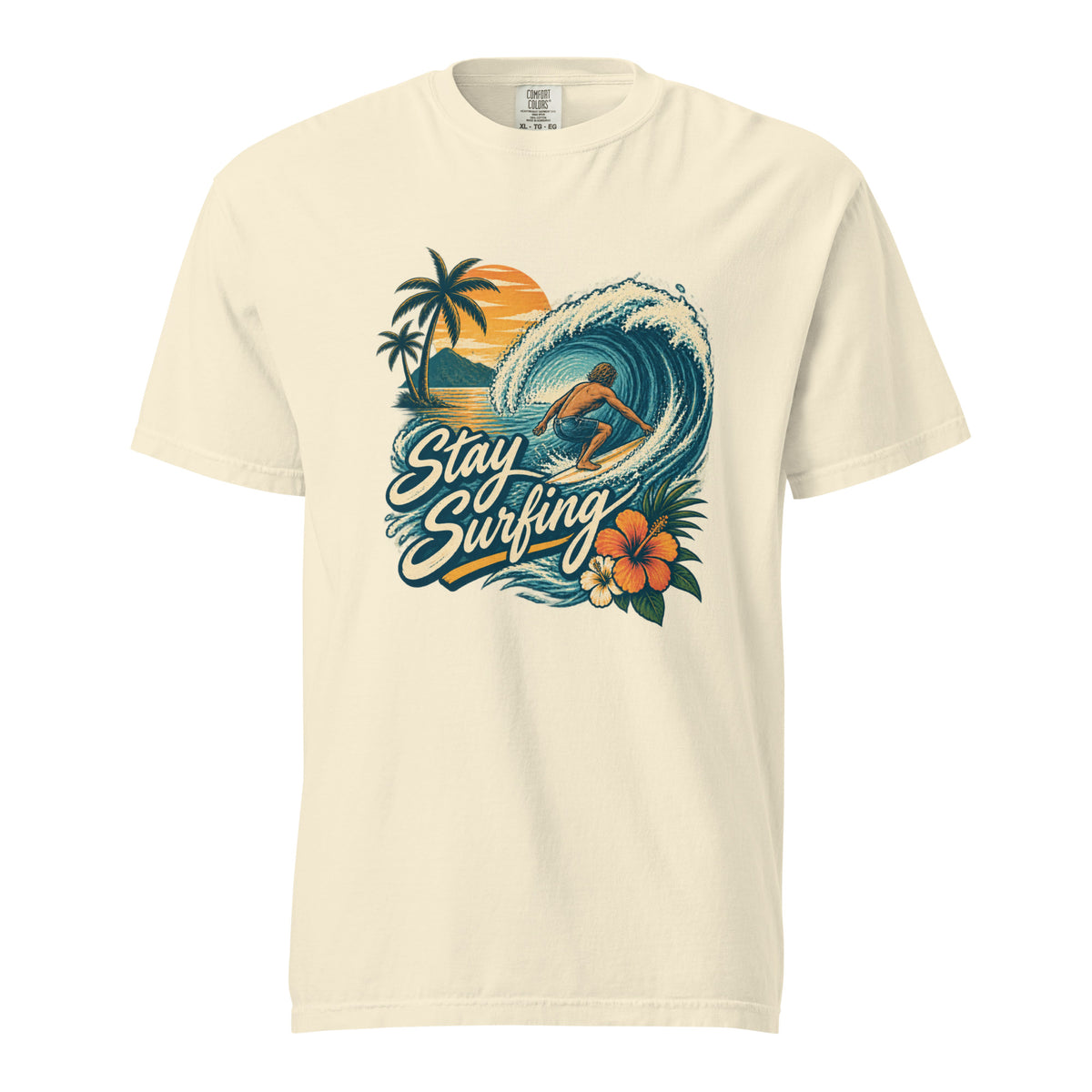 Ivory T-shirt with an illustrated surfer riding a wave, palm trees, sunset, tropical flowers, and Stay Surfing lettering