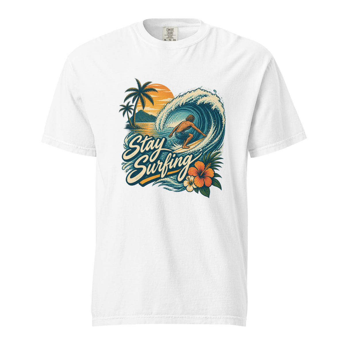 White T-shirt with a surfer riding a curling ocean wave, palm trees, sunset, tropical flowers, and Stay Surfing lettering.