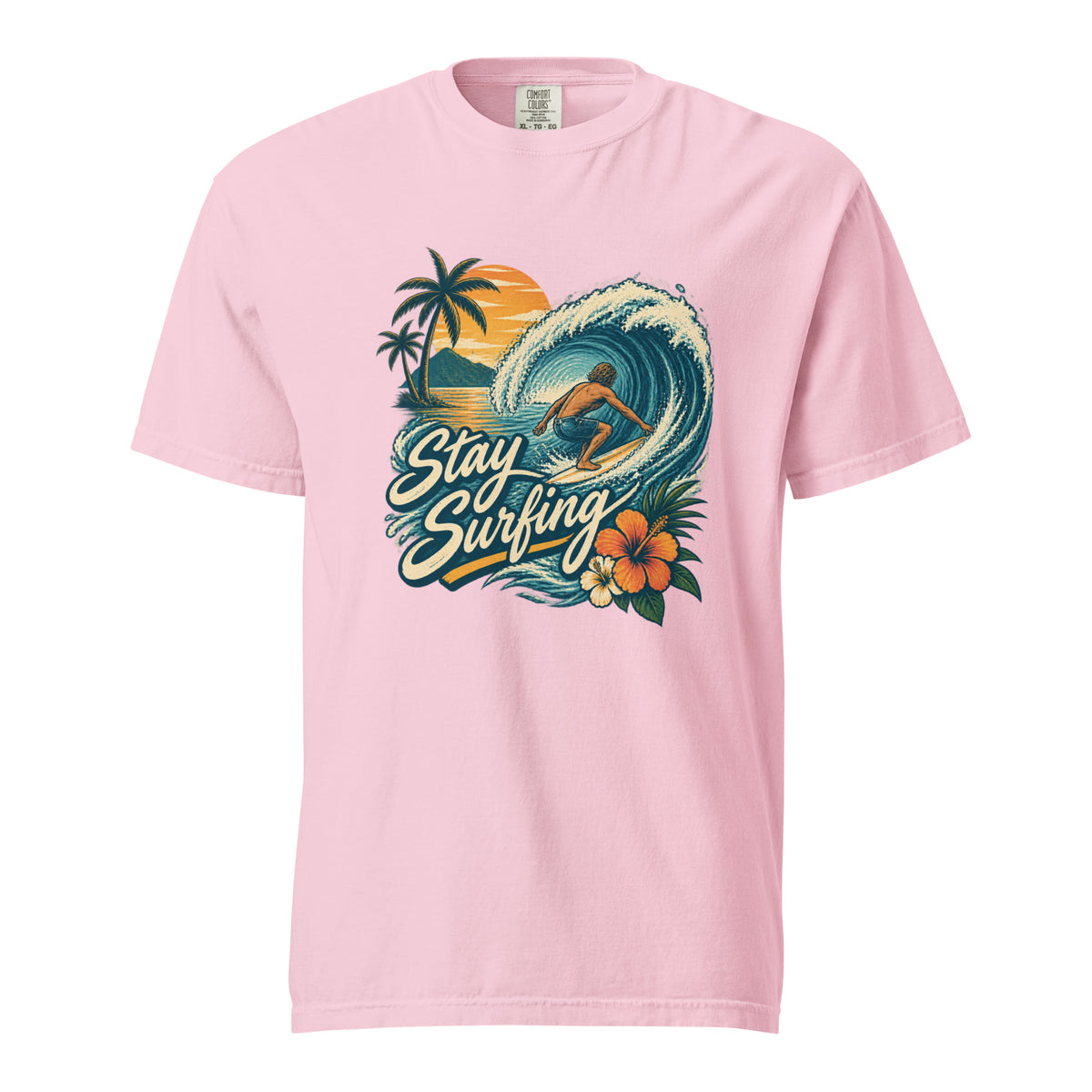 Blossom T-shirt featuring a tropical surfing illustration with a surfer riding a wave, palm trees, sunset, flowers, and “Stay Surfing” text.