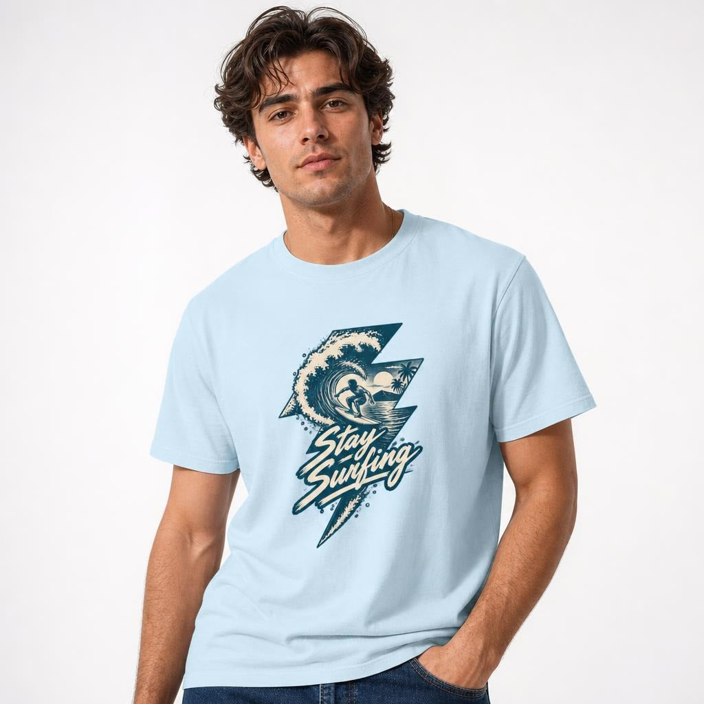 Stay Surfing t shirt in Chambray worn by a studio model in an upper-body three quarter left pose on a clean white background