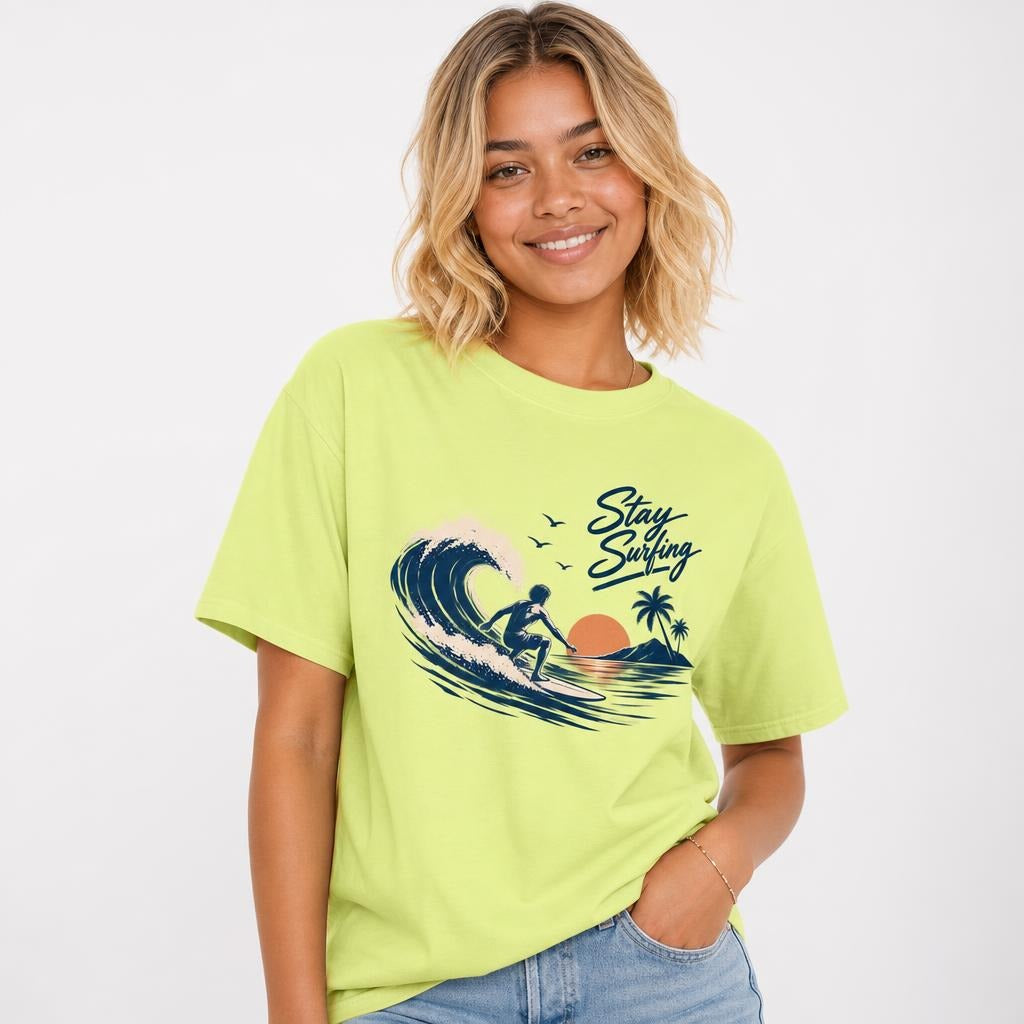 Front view of a Neon Lemon T-shirt with a navy Stay Surfing graphic showing a surfer riding a wave beside palm trees and birds.