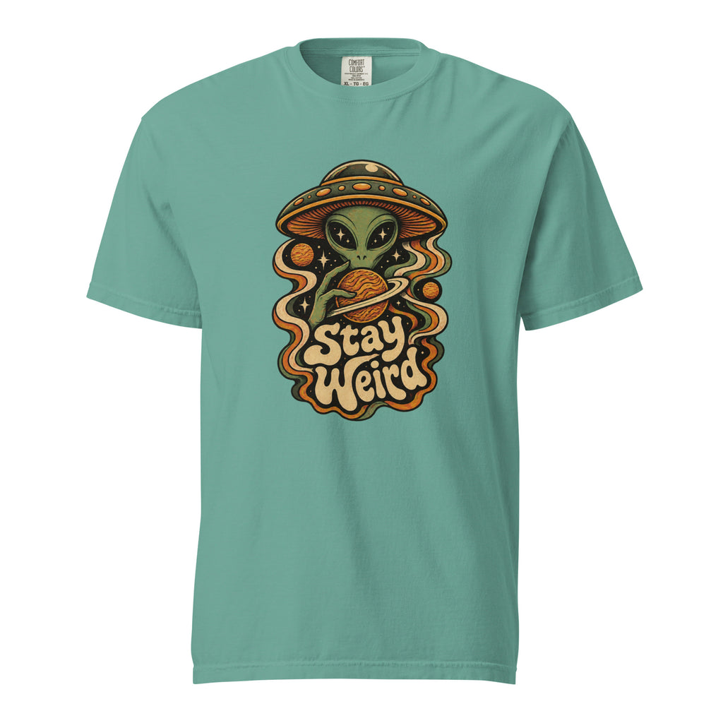Front view of a seafoam T-shirt with a green alien, flying saucer, orange planet, stars, and readable “Stay Weird” lettering.
