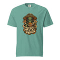 Front view of a seafoam T-shirt with a green alien, flying saucer, orange planet, stars, and readable “Stay Weird” lettering.