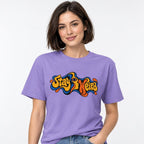 Eye t shirt in Violet worn by a studio model in an upper-body walking pose on a clean white background