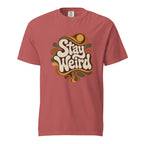 Front view of a Crimson T-shirt featuring “Stay Weird” in decorative retro typography surrounded by flowing psychedelic organic shapes.