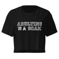 Adulting Is A Scam black crop top front product mockup with distressed white varsity text