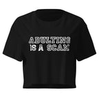 Adulting Is A Scam black crop top front product mockup with distressed white varsity text