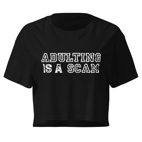 Adulting Is A Scam black crop top front product mockup with distressed white varsity text