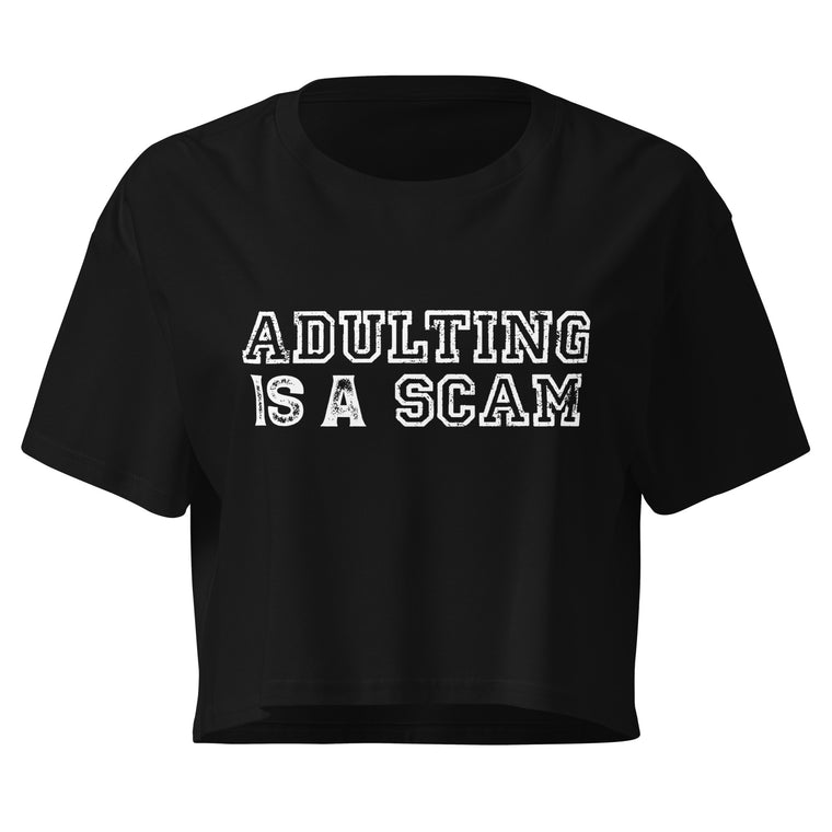 Adulting Is A Scam black crop top front product mockup with distressed white varsity text