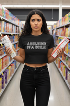 Model wearing the Adulting Is A Scam black crop top in a supermarket aisle