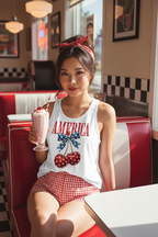 Model wearing the America Cherry Bow Racerback Tank Top in a retro diner scene