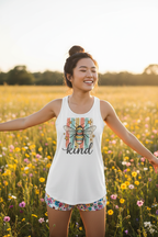 Model wearing the Bee Kind Racerback Tank Top in a sunny wildflower field