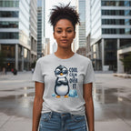 Person wearing a t-shirt with a penguin graphic and text in an urban setting
