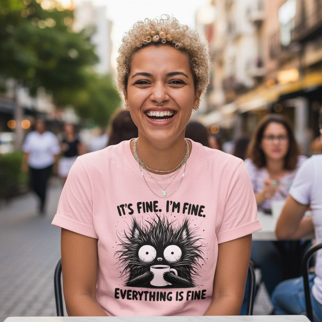 Person wearing a pink t-shirt with a cat graphic and text in an urban setting