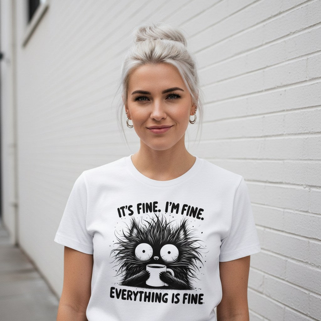 Woman wearing a white t-shirt with a graphic and text against a white wall.