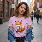 Woman wearing a pink t-shirt with a fox graphic and 'Zero Given' text on a city street.