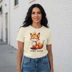 Woman wearing a t-shirt with a fox graphic and text, standing against a light-colored wall.