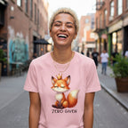 Person wearing a pink t-shirt with a fox graphic and 'Zero Given' text on a city street.