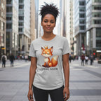 Person wearing a t-shirt with a fox graphic and text in an urban setting