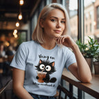 Woman wearing a t-shirt with a cat graphic and text in a cafe setting