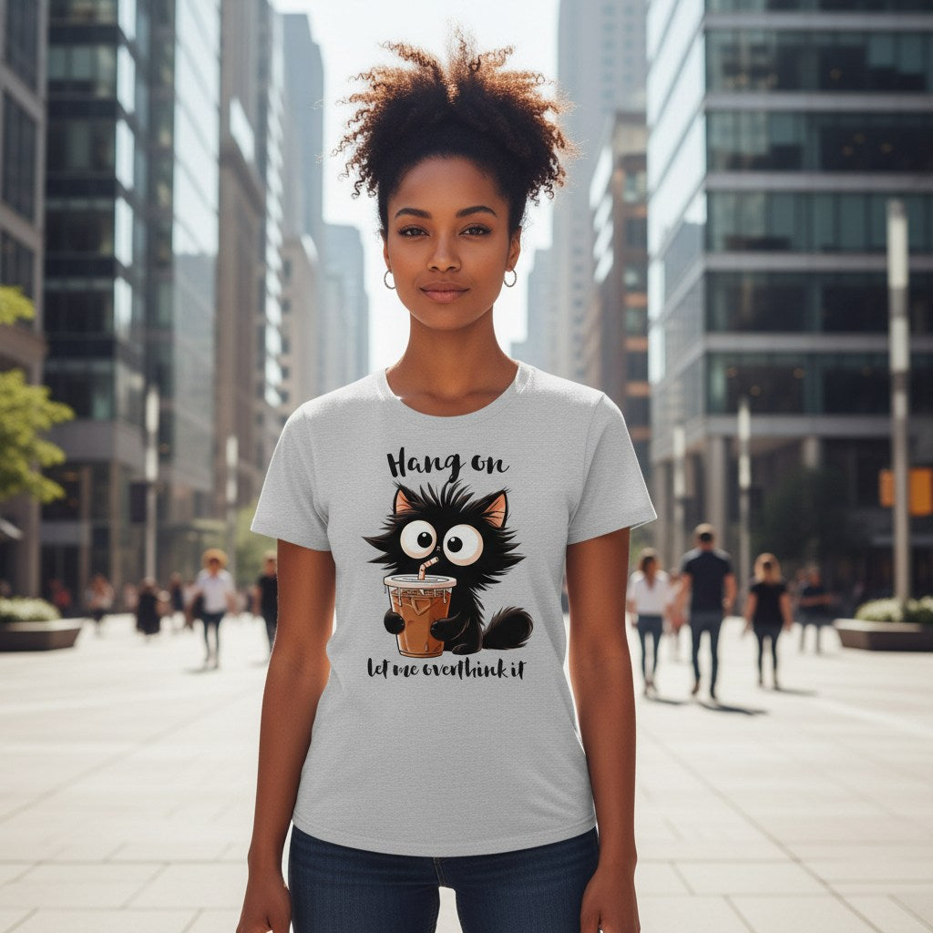 Woman wearing a t-shirt with a cat graphic and text in an urban setting