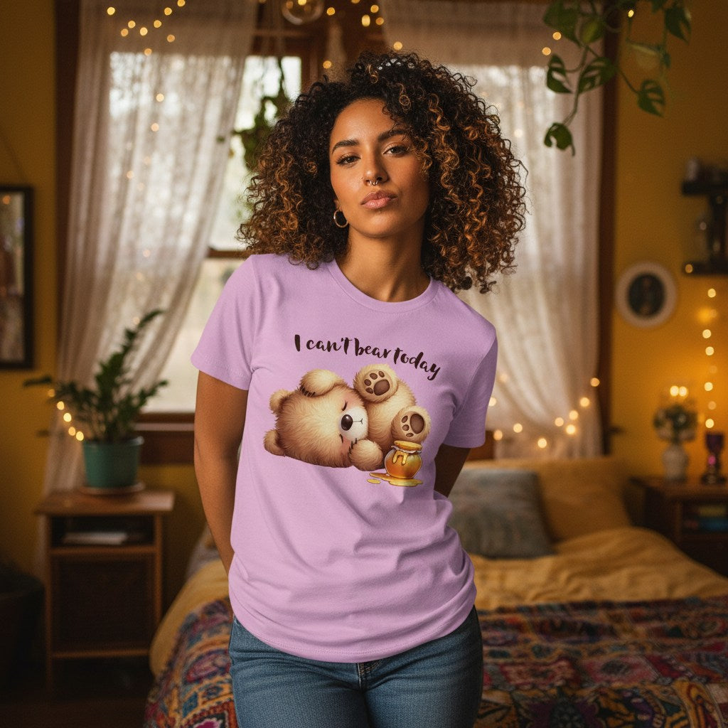 Woman wearing a purple t-shirt with a graphic design and text in a cozy room.