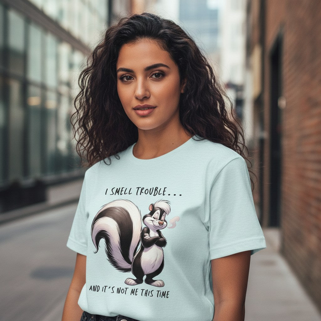 Woman wearing a light blue t-shirt with a skunk graphic and text in an urban setting