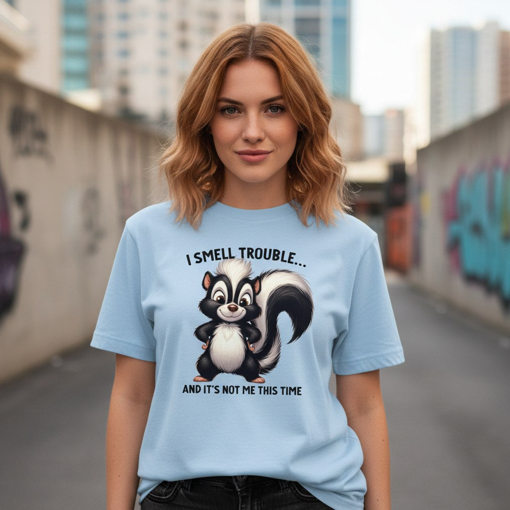 Woman wearing a light blue t-shirt with a skunk graphic and text in an urban setting