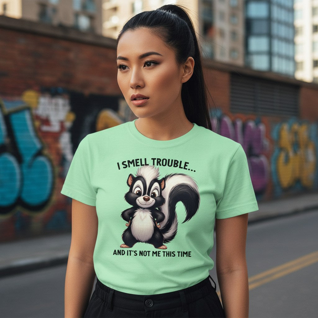 Woman wearing a green t-shirt with a skunk graphic and text in an urban setting