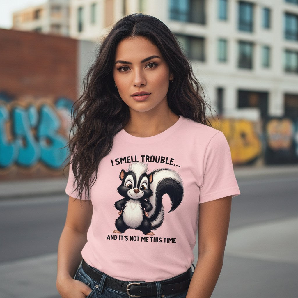 Woman wearing a pink t-shirt with a skunk graphic and text in an urban setting