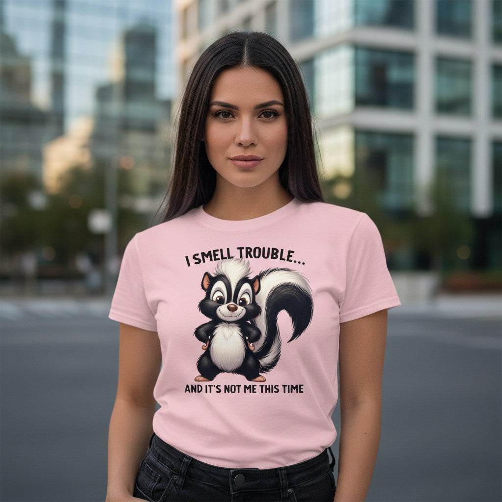 Woman wearing a pink t-shirt with a skunk graphic and text in an urban setting
