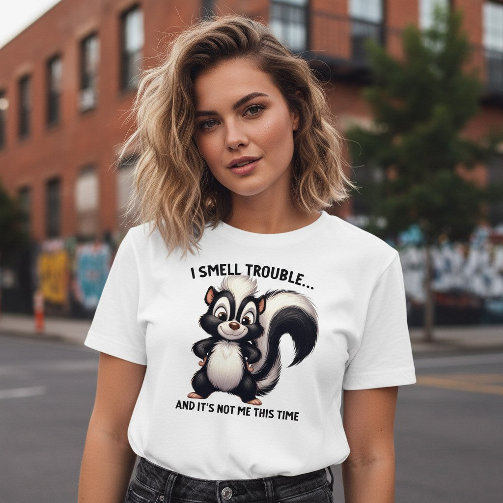 Woman wearing a white t-shirt with a skunk graphic and text on a city street.