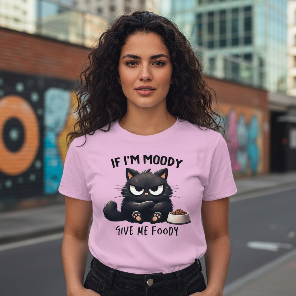 Woman wearing a pink t-shirt with a black cat graphic and text in an urban setting
