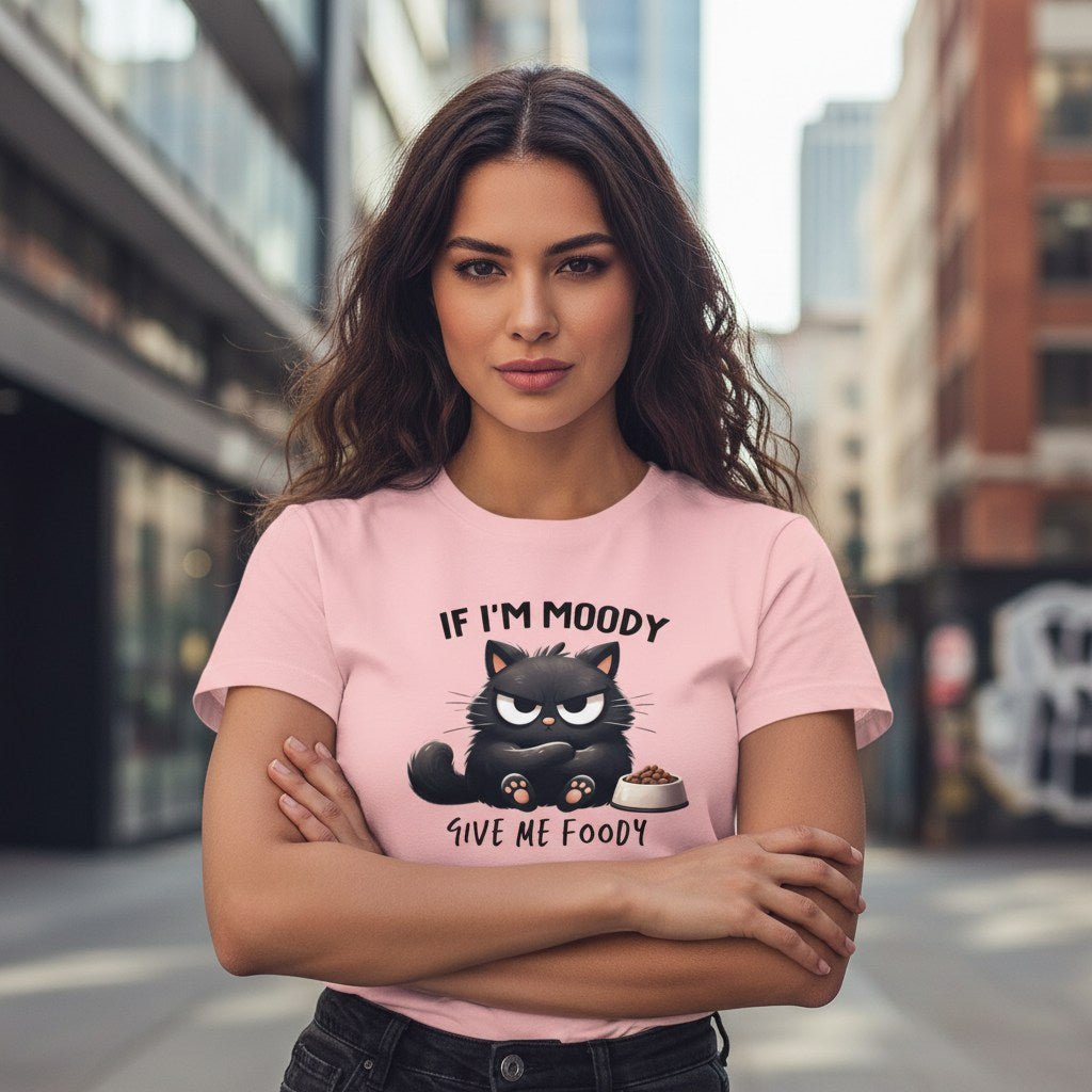 Woman wearing a pink t-shirt with a cat graphic and text in an urban setting
