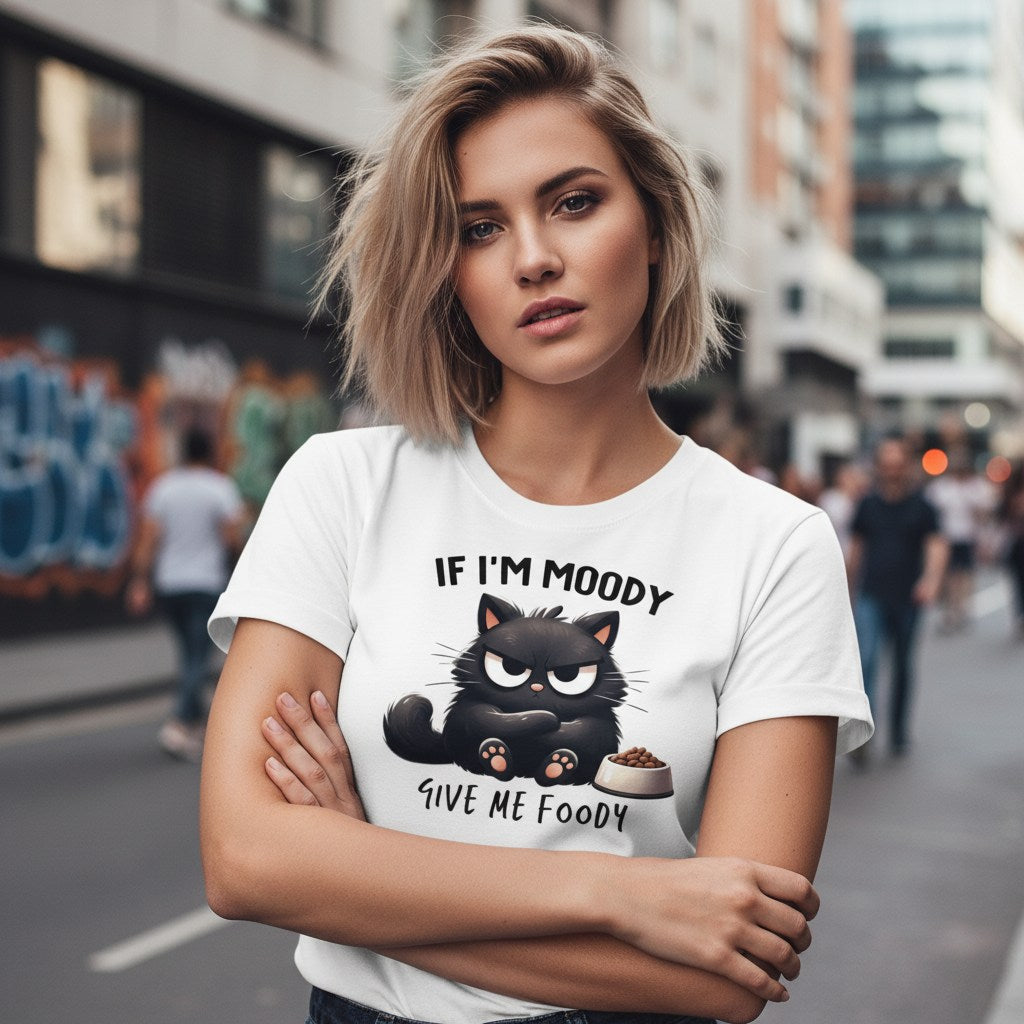 Woman wearing a white t-shirt with a black cat graphic and text on a city street.