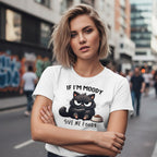 Woman wearing a white t-shirt with a black cat graphic and text on a city street.
