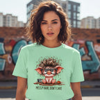 Woman wearing a light green t-shirt with a cartoon pig design and text in an urban setting.
