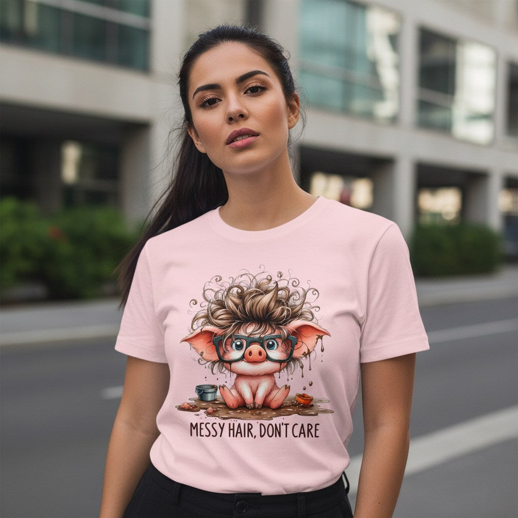 Woman wearing a pink t-shirt with a cartoon pig design and text 'Messy Hair, Don't Care' on a city street.
