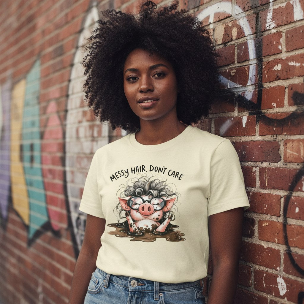 Woman wearing a t-shirt with a graphic and text, standing against a graffiti-covered brick wall.