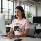 Woman wearing a pink t-shirt with a cat graphic and text in an office setting